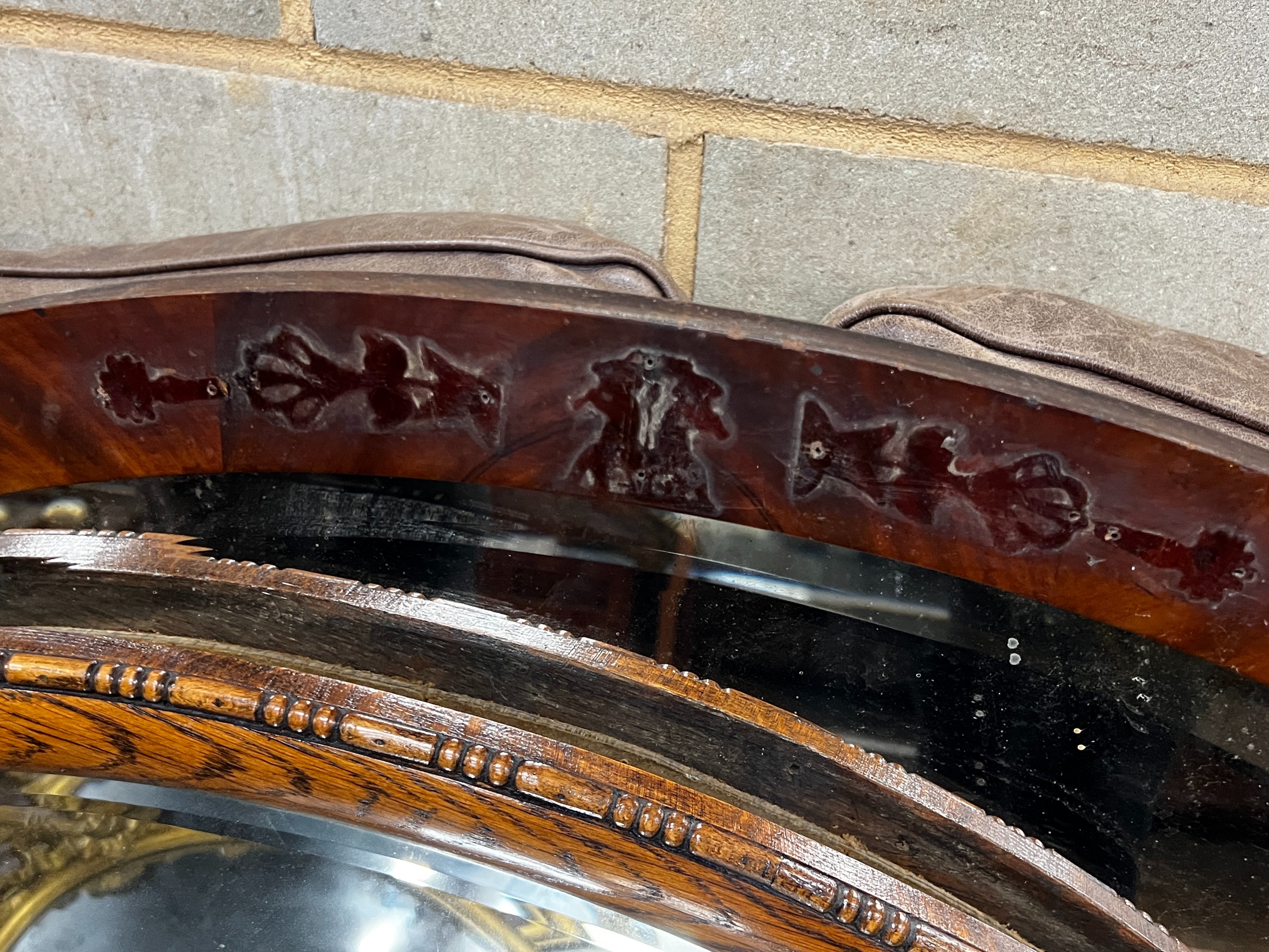 Two early 20th century oval wall mirrors, larger width 86cm